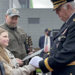Miss Symphony Ames receives an award from MG Coffey
